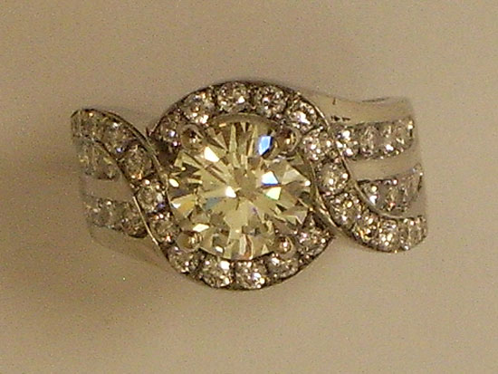 Round Brilliant Diamonds With Channel Setting Swirl Design Engagement Ring